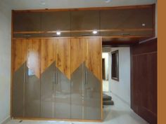 an empty room with wooden cupboards and glass doors