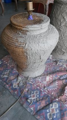 two large vases sitting on top of a rug