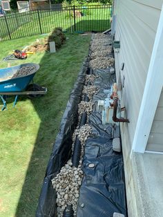 the back yard has been laid up with rocks and gravel to create a drainage system