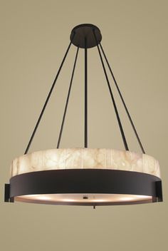 a chandelier hanging from the ceiling with marble and metal fixtures in an industrial style