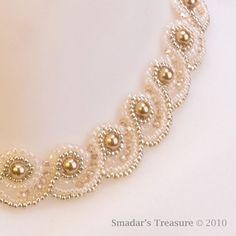 a white necklace with pearls and beads on it