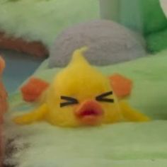 a yellow stuffed animal laying on top of a bed