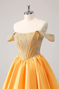 a yellow dress on a mannequin dummy with an off the shoulder neckline