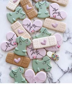 decorated cookies are arranged on a marble surface