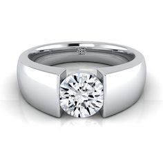 a white gold ring with a diamond in the center