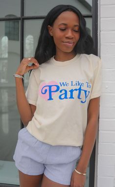 Who doesn't love a little party with the girl of the hour?! This cream colored t-shirt features a royal blue font with a bubble gum pink heart that your girls will love! Maggie is 5'3" and is wearing size XL Heather is 5'9" and is wearing size medium sizing guide: fits true to size - size up for an oversized fit medium measurements: 41" bust and 28.5" length 100% cotton Use code BACH20 for 20% off an order of 6+ items from the bridal collection. Some exclusions apply. WE ONLY OFFER STORE CREDIT Summer Party Top With Heart Print, Summer Party T-shirt With Slogan, Fun Party T-shirt With Text Print, Cute Party T-shirt With Text Print, Spring Crew Neck T-shirt For Bachelorette Party, Fun T-shirt For Summer Gender Reveal, Summer Graphic Tee For Gender Reveal, Playful Party Tops With Letter Print, Fun Summer Tops For Gender Reveal