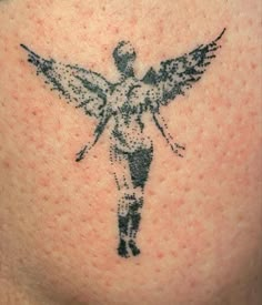 an angel tattoo on the back of a woman's shoulder