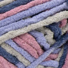 a pile of multicolored crocheted rugs