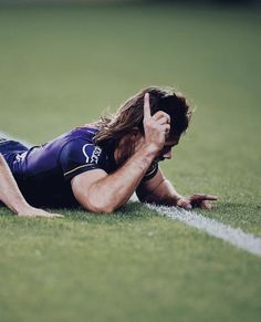 a man laying on top of a soccer field