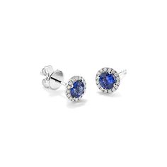 A sparkling halo of natural diamonds highlights the traditional blue natural sapphire at the center of these 14-karat white gold stud earrings. Crafted with care  the sapphires are hand matched for consistent color and beauty. Blue Sapphire Diamond Earrings With Halo Setting, Sapphire Diamond Earrings With Halo Design, White Gold Stud Earrings, White Gold Earrings Studs, Step Kids, Gold Stud Earrings, Gold Stud, Natural Sapphire, Diamond Halo