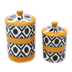 two black and white canisters with yellow accents on the top one has an orange lid