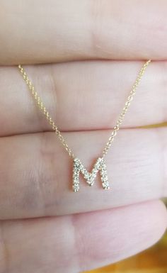 "14K SOLID YELLOW GOLD DAINTY INITIAL NECKLACE WITH DIAMONDS Metal : 14K Solid Gold Necklace Length : 16 inches / 40cm Letter Height : 7.00mm Letter Width : 7.50mm Diamond : 19 Diamonds --- Nice White Color Sparkle Diamonds ---- G-H color SI2 clarity Total Carat: 0.08ct to 0.12cts (Depending on the letter) ---MADE IN USA--- ---All letters from A to Z are available. Please indicate your letter choice in the \"notes to seller\" section on the order. ---This is a beautiful 14K Solid Yellow Gold Dai Gold 14k Diamond Initials Necklace, Gold Diamond Initials Necklace In 14k Gold, 14k Gold Diamond Initials Necklace Gift, Gold Sterling Silver Diamond Necklace With Initials, M Necklace, Butterfly Necklace Gold, Dainty Initial Necklace, Diamond Initial Necklace, Gold Letter Necklace