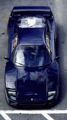 a blue sports car parked in a parking lot