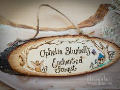 a wooden sign that says, ophelia bluebells enchanted forest