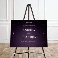 an easel with a wedding sign on it sitting in front of a white wall