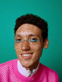 a woman with freckles on her face and sweater