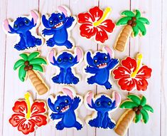 decorated cookies in the shape of cartoon characters with palm trees, flowers and coconuts