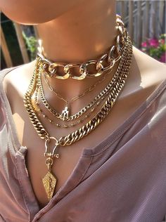 This handmade 24 K gold  plated chain layered multi stand stacked punk goth edgy style necklace set is a stunning piece of jewelry that is perfect for those who love bold and edgy accessories. This is two necklaces, the big chunky choker that is adjustable with a built-in extender from 14" to 17", and the 4-strand drop festoon design necklace (also adjustable 15" to 18"). Adding depth and dimension to the piece is a u lock and spearhead pendant. Very punk, grunge aesthetic! This necklace set is an excellent handmade gift for someone special. It is a perfect choice for those who love alternative and goth styles, as well as anyone who wants to make a statement with their jewelry. PLEASE NOTE FOR RETURNS! If I accept returns on your purchase (check when ordering, some items are "no returns") Multi Chain Choker Necklace With Cross, Luxury Double Chain Multi-strand Necklace, Big Gold Necklace, Edgy Accessories Jewelry, Statement Aesthetic, Chain Stack, Goth Styles, Gothic Choker, Chunky Choker