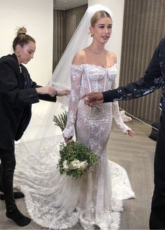 the bride is getting ready to walk down the aisle in her wedding dress and veil