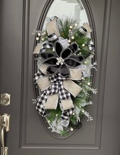 ⚫ This elegant Black and White Buffalo Check Teardrop Swag will make your front door the envy of the neighborhood! Perfect for a Winter Wedding or a Retirement Party, the Black Poinsettia stands out as the centerpiece, encircled by Black and White Plaid and Gray Flannel ribbons dusted with Silver Glitter. Accents of berries, icicles, long needle pine, and glittered pinecones add a captivating charm to this extravagant design. ⚫ This swag is constructed on a 24-inch teardrop evergreen base with m Winter Wedding Black, Glam Winter Wedding, Swag For Front Door, Door Swags, Winter Swag, Teardrop Swag, Winter Wreaths, Black And White Flannel, Door Swag