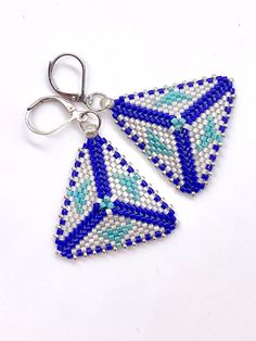 Triangle earrings, made with high quality white pearl, royal blue and turquoise colors Japanese miyuki seed beads.Lever back ear closure is silver plated, nickel free.Very lightweight, only 0.18 oz. Suitable for any occasion.Pictures are taken inside and outside. Due to different light sources, colors may look different.If you would like additional pictures, please don't hesitate to reach out. Blue Handwoven Dangle Jewelry, Unique Blue Beaded Earrings Nickel-free, Unique Blue Beaded Nickel-free Earrings, Blue Handwoven Beaded Earrings For Gift, Handwoven Blue Beaded Earrings For Gift, Adjustable Handwoven Blue Earrings, Silver Handwoven Dangle Jewelry, Colors Japanese, Triangle Earrings