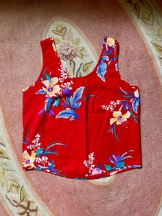 This is perfect and barely worn 1980's Avon brand cherry red tank top with hawaiian floral print Boxier fit to tank Thicker straps Scoops fairly low in the back Cotton material Seems barely worn in perfect condition So vibrant and colorful Tag is in near perfect condition Fits a womens medium Measurements are approximate and taken flat so please double bust and waist for more accurate sizing Bust: 18 in Waist: 18 in Length: 21.5 in All sales are final Thanks for checking out Cereal Vintage Thrif Hawaiian Floral Print, Red Tank Top, Avon Vintage, Red Tank, Red Tank Tops, Cotton Tank Top, Vintage Avon, Tropical Floral, 1980s Vintage