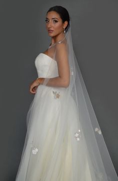 a woman wearing a wedding dress and veil