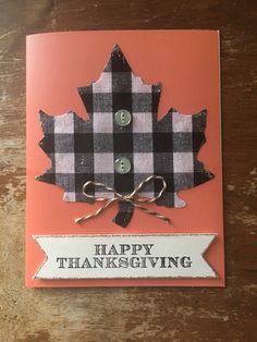 a happy thanksgiving card with a plaid maple leaf on the front and button holes in the back