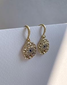 Introducing the Evil Eye Earrings, a mesmerising blend of protection and elegance, crafted from high-quality brass and plated with lustrous 18K gold. These greek earrings feature a distinctive hammered texture that adds a touch of artisanal charm, making each pair unique. The focal point of these nazar earrings is the intricate evil eye pattern, formed by sparkling cubic zirconia crystals. The crystals are meticulously set to create a captivating and protective symbol, known for warding off nega Tarnish Resistant Diamond Round Earrings, Tarnish Resistant Round Diamond Earrings, Teardrop Earrings With Diamond Eyes, Gold Halo Design Cubic Zirconia Earrings, Dazzling Crystal Earrings For Gift, Tarnish Resistant Round Diamond Earrings For Wedding, Tarnish Resistant Diamond Wedding Earrings, Tarnish Resistant Round Plug Earrings For Gift, Wedding Diamond Earrings Tarnish Resistant