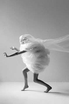 black and white photograph of a woman in a dress with a veil on her head