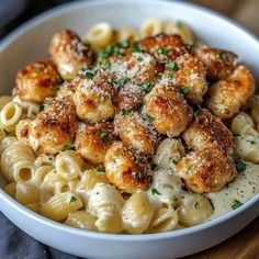 a white bowl filled with macaroni and cheese covered in parmesan sprinkles