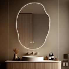 a bathroom with a round mirror above the sink and two bottles on the counter next to it