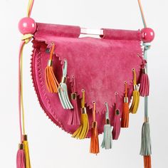 A Rare And Unique Vintage Crossbody Bag From Givenchy, This Fun Suede Saddle Bag In Pink Hangs From A Pink Metal Bar With Spheres On Each Side And A Gold-Tone Logo Plaque At The Centre. The Pinked Edges Compliment The Whimsical Vibe Of The Multicolour Leather Tassels That Adorn The Flap And The Strap. Secured By A Magnetic Closure, The Flap Opens To A Spacious Main Compartment Lined With Textured Pink Leather And Equipped With A Zipper Pocket. Condition: Great; Moderate Wear On Corners And Tassels, Comes With Dust Bag Approximate Measurements: Height: 10” (25 Cm) Width: 16.5” (42 Cm) Depth: 3” (7.5 Cm) Strap Drop: 17” (43 Cm) Composition: Suede, Leather, Metal Designer Bags With Tassels, Rectangular Pink Bag With Fringe, Pink Fringe Bag For Daily Use, Pink Bags With Tassels For Daily Use, Luxury Top Handle Shoulder Bag With Fringe, Pink Rectangular Tassel Bag, Pink Fringe Shoulder Bag, Pink Fringe Bag For Everyday Use, Chic Top Handle Shoulder Bag With Tassels