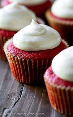 red velvet cupcakes with white frosting on top