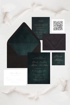 an assortment of wedding stationery and envelopes on top of each other, with the same