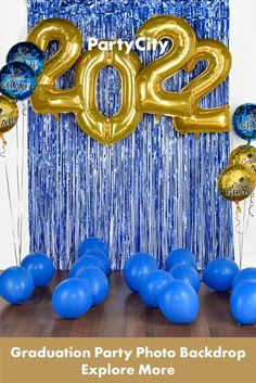 graduation party photo backdrop with balloons and streamers in blue, gold and silver colors