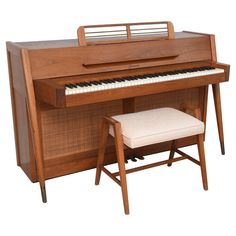 an upright piano with bench and stool