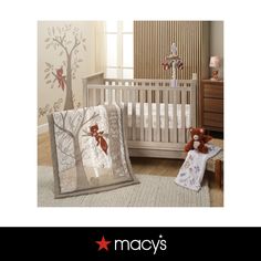 a baby crib bedding set with a teddy bear and tree design on it