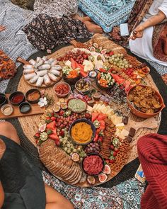 people sitting around a large platter of food