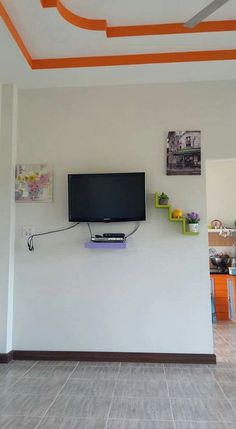 a flat screen tv mounted to the side of a wall