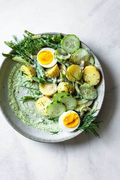 a white plate topped with cucumber and boiled eggs