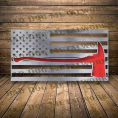 an american flag with a hammer in it on a wooden floor next to wood planks