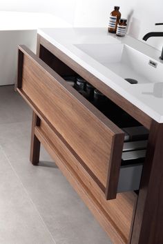 a bathroom with a sink and wooden cabinet