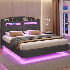 a large bed with purple lights on the headboard and foot board in a bedroom