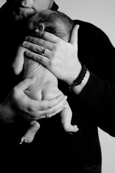 a man holding a baby in his arms