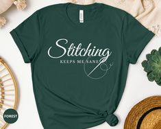 a t - shirt that says stitching keeps me sane on it next to some other items