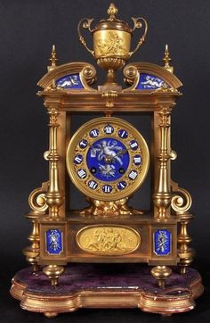 an ornate clock with blue and gold decorations