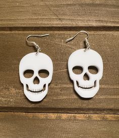 "Acrylic skull earrings are 1.5\" long and are attached to hypoallergenic ear wires.  They are sold in pairs. Great for a Halloween party." Handmade Skull Earrings For Halloween, White Skull Jewelry For Day Of The Dead, White Skull Print Jewelry, Halloween Skull Print Earrings, Halloween Skull Jewelry With Ear Wire, White Skull-shaped Halloween Jewelry, Halloween Skull Jewelry In White, White Skull Jewelry For Halloween, Halloween White Skull Jewelry