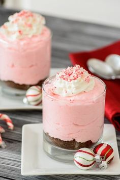 two small desserts with candy canes on the side