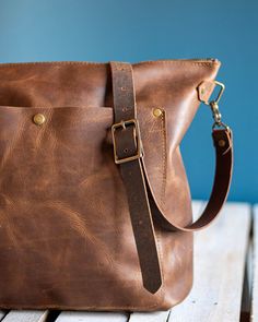 "Welcome to your new favorite handmade leather tote bag. This handbag converts from a zipper backpack to crossbody purse with a few quick clicks of our versatile strap. Handcrafted in Asheville, NC by In Blue Handmade. As of March 19th, 2020, each bag purchase from In Blue Handmade gives 50 meals to a network of 60,000 food banks nationwide during this unprecedented world crisis. See listing pictures for more information, and feel free to reach out with questions! Which color is which? Good ques Everyday Shoulder Bag Backpack With Leather Lining, Everyday Shoulder Bag With Leather Lining And Backpack Shape, Everyday Shoulder Bag With Leather Lining Backpack Style, Everyday Leather-lined Backpack Shoulder Bag, Everyday Rectangular Leather Backpack With Waxed Finish, Rectangular Leather Backpack With Waxed Finish For Everyday, Everyday Use Leather Backpack With Waxed Finish, Everyday Standard Backpack With Waxed Finish, Rectangular Everyday Leather Backpack With Waxed Finish